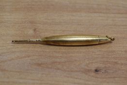 A small yellow metal propelling pencil with ring top. Engraved