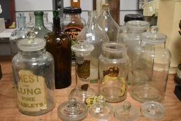 An assorted collection of mid-20th Century glass chemist's bottles, the largest measures 37cm high
