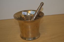 An late 18th/early 19th century bell metal pestle and mortar, of traditional design, the pestle with