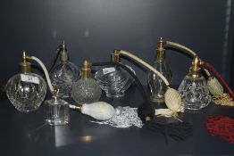 A selection six of cut and pressed glass perfume atomisers and single glass scent bottle