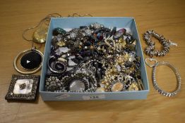 A collection of costume jewellery including paste set bracelets, statement necklaces, a large yellow