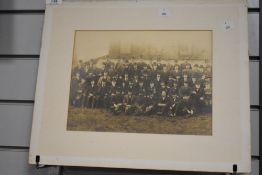 A mounted photographic print of a group of 19th Century men