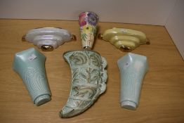 Six assorted wall pockets including a Burleigh Ware tiger's claw design having raised squirrel, deer