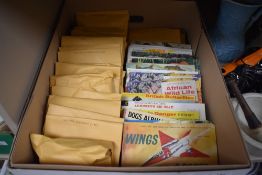 A collection of tea cards some in presentation books, some collected into envelopes.