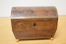 A 19th/20th century yew wood two compartment tea caddy, of domed and hinged rectangular form with