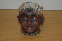 A Continental bisque porcelain lidded pot, formed as the head of a Romany child, unmarked, 11.5cm