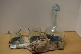 An attractive molten/moulded glass and natural wood section two glass decanter set and stand, The