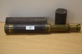 A 19th century brass three draw telescope, with leather grip and original card 'case'