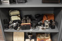 A pair of 1970s Hanimex 7X 15x35 magnification binoculars with textured grip, and a selection of