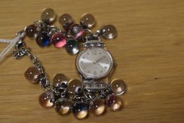 A Swatch watch with beaded wristband