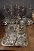 A pair of silver plated three sconce candelabra, two silver plated serving dishes and two baskets