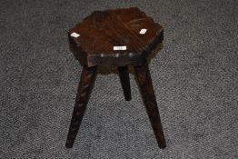 A carved and stained pine hexagonal stool.