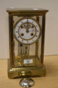 A large 19th century French brass four-glass mercury pendulum mantel clock, of 'carriage clock'