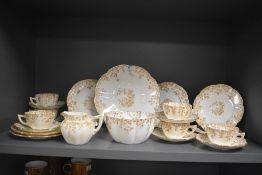 A late 19th/early 20th century Foley China teaset, decorated with gilt rims and transferred ivy