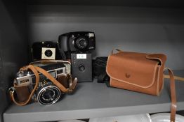 Four cameras. A Kodak Brownie 127 in soft case, a No2 Cartridge Hawkeye Model B box camera (AF) in