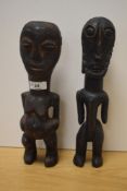 Two African carved hardwood tribal statuettes, to include a West African fertility figure, both