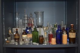 A selection of various chemist/apothecary glass bottles, some coloured, some with labels, some