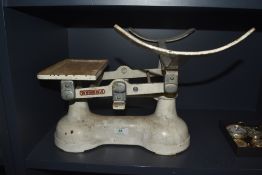 A set of vintage English white painted balance scales, marked To Weigh 28LB, lacking pan and