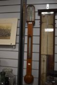 A late 19th Century oak cased stick barometer, having a double canted and silvered register/