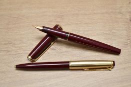 A Montblanc 221 converter fill fountain pen and ballpoint pen in burgundy with gold trim and gold
