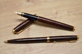 A Parker 75 converter fill fountain pen and ballpoint pen set in thuya lacque. Cap badly fitting