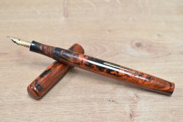 A Mabie Todd & Co Swan Self Filling lever fill fountain pen in black and red hard rubber with