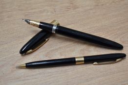 A Sheaffer Statesman Snorkel fill fountain pen and propelling pencil set in black with white spot