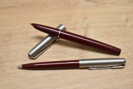 A Parker 51 aerometric fill fountain pen and ballpoint pen set in burgundy with a brushed steel cap