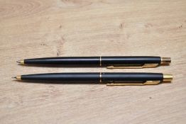 A Parker Classic ballpoint pen and propelling pencil set in matte black with gold trim