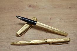 A Parker 61 aerometric fill fountain pen and ballpoint pen set in rolled gold stratus design