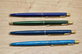 Four Parker Classic ballpont pens in various colours of lacque with gold trim