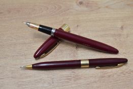 A Sheaffer Statesman snorkel fill fountain pen and propelling pencil set in burgundy with white spot