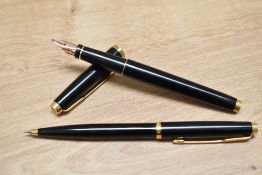 A Parker 75 converter fill fountain pen and propelling pencil set in black lacque