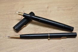 A Mabie Todd & Co Swan L205/60 twist fill fountain and propelling pencil set in black chaised with
