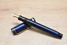 A Parker Duofold Senior Lucky Curve button fill fountain pen in lapis lazuli blue with white