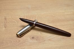 A Parker 51 pump fill fountain pen in cordovan brown with flighter cap having gold trim