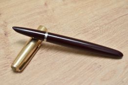 A Parker 51 aerometric fill fountain pen in cordovan brown with rolled gold cap