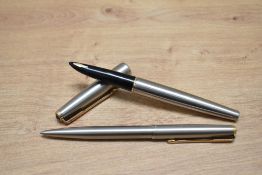 A Parker 61 Flighter aerometric fill fountain pen and ballpoint pen set insteel with gold trim