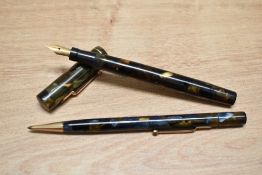A Mabie Todd & Co Swan SM2/58 lever fill fountain pen and propelling pencil set in green, gold and