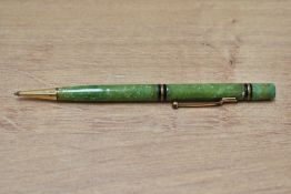 A Mabie Todd Swan propelling pencil with two gold on black band (142/50) in jade green