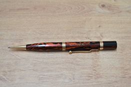 A Mabie Todd Swan Eternal propelling pencil in black and red hard rubber. Engraved