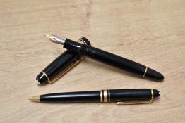 A Montblanc Meisterstuck 142 fountain pen and propelling pencil set in black with gold trim having