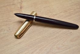 A Parker 51 aerometric fill fountain pen in cordovan brown with a gold filled cap