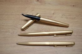 A Parker 61 aerometric fill fountain pen and two ballpoint pen in rolled gold