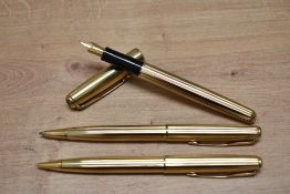 A Parker Sonnet converter fill fountain pen, ballpoint pen and propelling pencil set in reeded gold