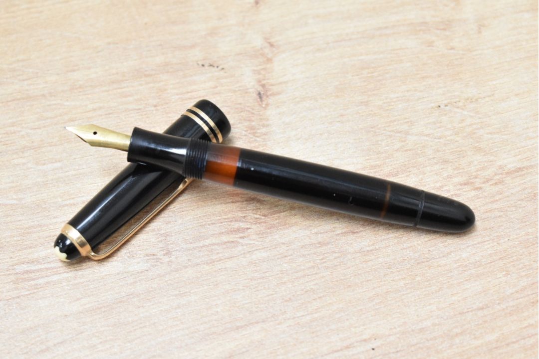 A Montblanc 242G piston fill fountain pen in black having Montblanc 14C 585 nib - Image 1 of 3