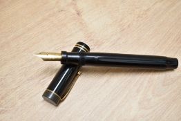 A Parker Duofold Senior Lucky Curve button fill fountain pen in black with two narrow bands to the