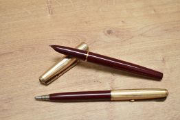 A Parker 51 aerometric fill fountain pen and propelling pencil set in burgundy with a rolled gold