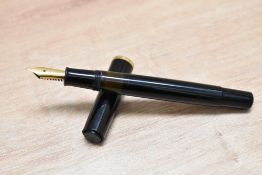A Pelikan pump fill fountain pen in black with Pelikan F nib. Clip missing