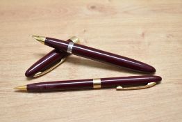 A Sheaffer Touchdown Sovereign pundger fill fountain pen and propelling pencil set in burgundy